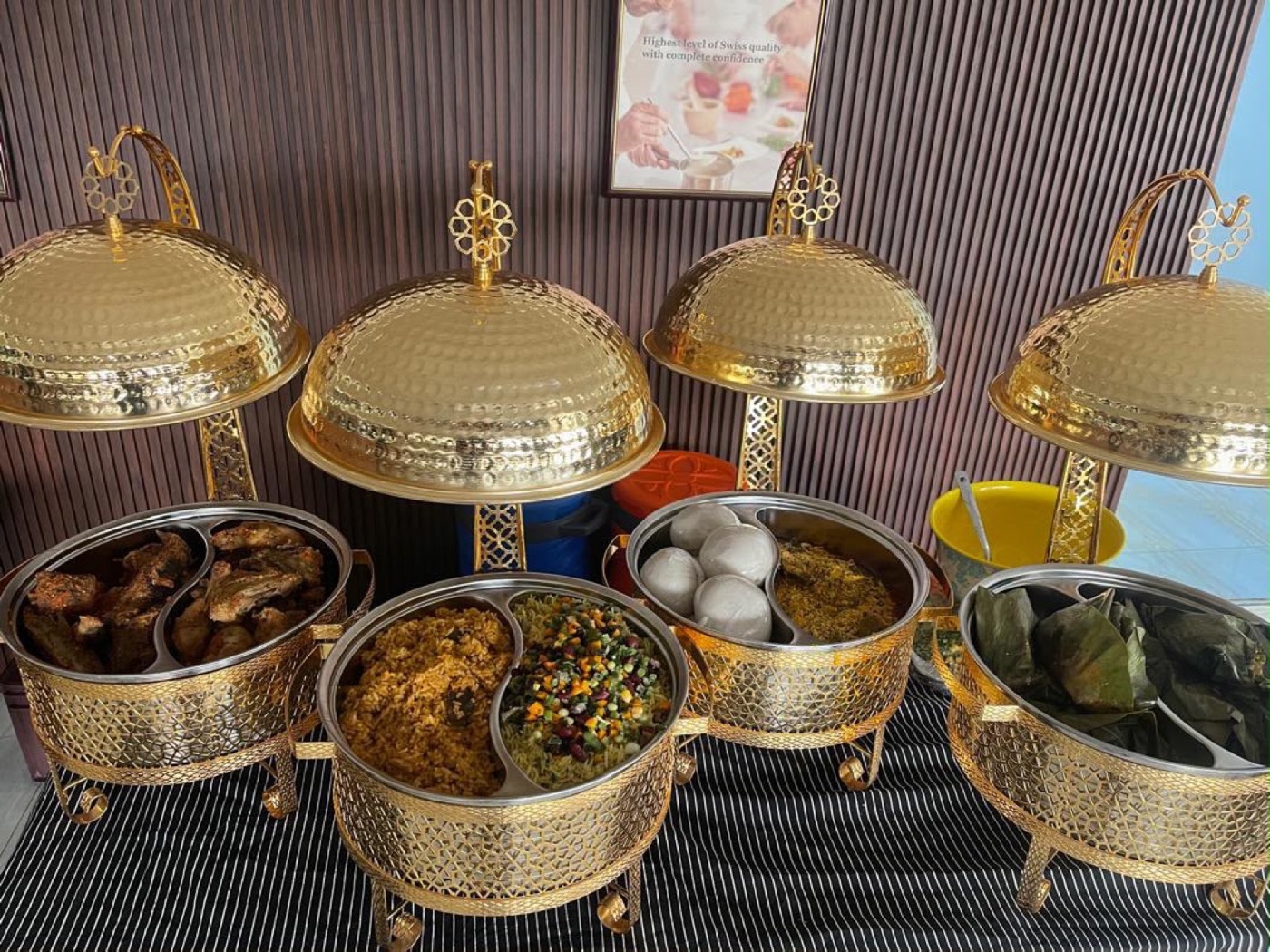 Gold chafing dishes laid out for a buffet service