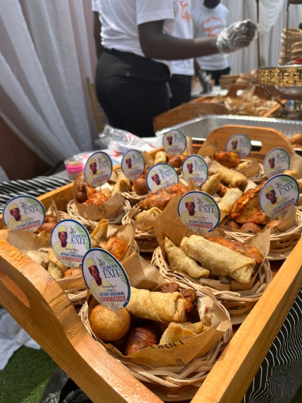Zoaney staff serving packaged small chops at an outdoor event