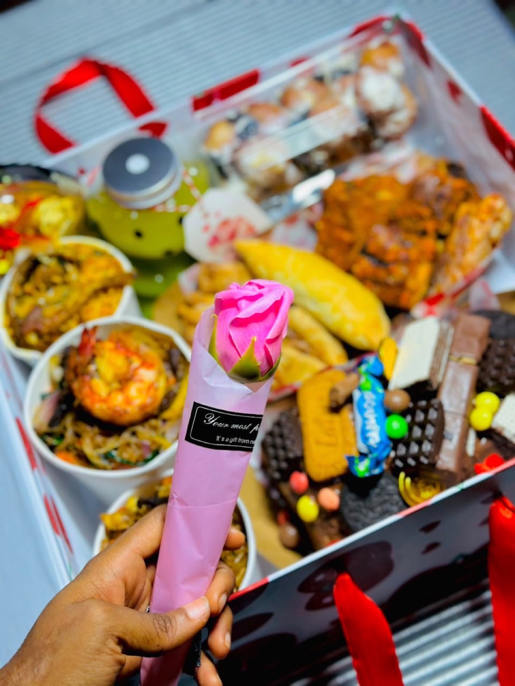 A celebration box of small chops, rice and sweets